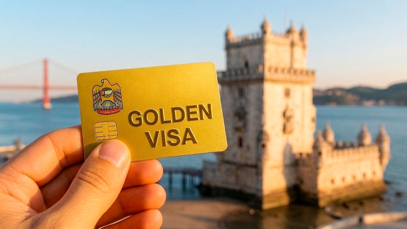 A hand holding a gold card with the inscription "Golden Visa" in front of the Belém Tower in Lisbon, symbolizing residency through investment in Portugal.